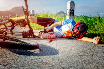woman cycling in hurt and injuried of leg after accident clashed, with mortal wound and bleeding of...