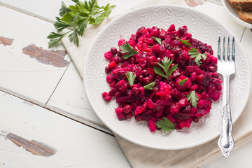 Fresh homemade Beetroot salad Vinaigrette in a white bowl. Traditional Russian food. Copy space