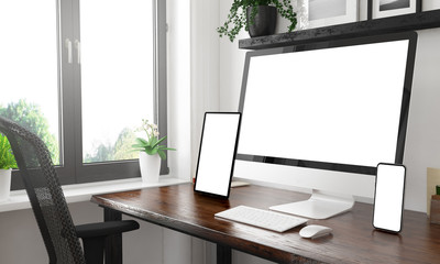 black and white desktop with three devices showing black screens