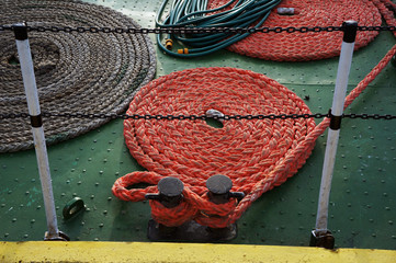 Circle hanks of rope on deck of fishing boat.