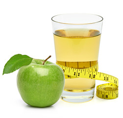Green apples and glass of apple juice with measuring tape isolated on white background.