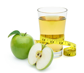 Green apples and glass of apple juice with measuring tape isolated on white background.