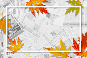 Lots of blurred newspapers and decorated paper frame with autumn leaves, creative news background with copy space