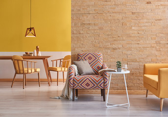 Yellow room wooden furniture and brick wall concept.