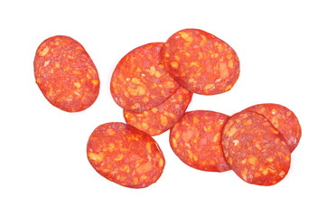 Spicy salami sausage slices isolated on white background, top view
