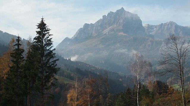 Autumn view of the Hochk√∂nig near Bischofshofen, Salzburger Land, Austria. Fall colors in the trees, slightly hazy.