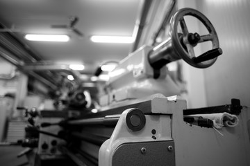 Lathe machine for metal cutting, machinery center background.