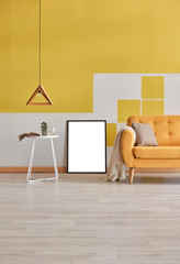 Wooden lamp, yellow sofa with frame decoration in the yellow white wall background.