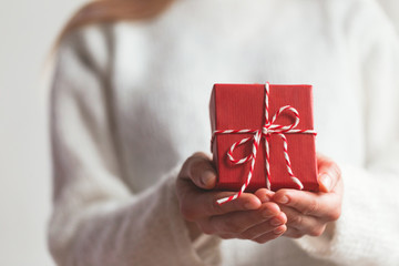 Red gift in a hands.