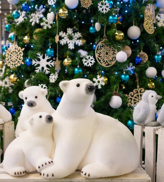 Figurine polar bears toy, near the Christmas tree. Christmas decor, xmas tree decorations. Christmas composition. Christmas toy white bears.