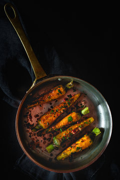 Healthy roasted carrots On dark background