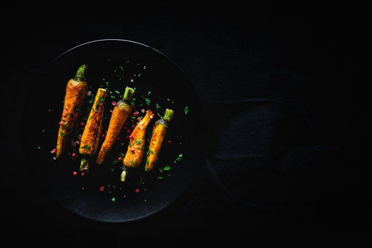 Healthy roasted carrots On dark background