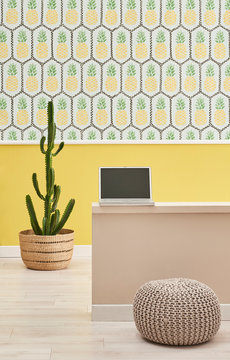Laptop and pineapple wallpaper decoration style.