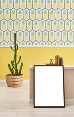 Frame interior concept in the room, wicker vase of cactus and pineapple wallpaper.