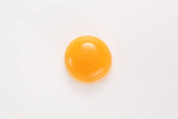 Raw egg yolk on a white background. View from above. - obrazy, fototapety, plakaty
