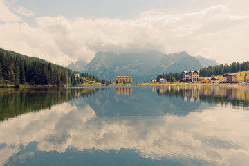 Fototapeta premium Auronzo di Cadore, Italy August 9, 2018: Misurina Mountain Lake. Beautiful tourist place with houses and cafes.