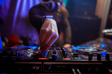 Dj playing the track in the nightclub at party closeup