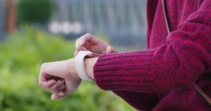 Woman use of smart watch in the park