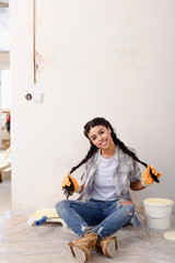 beautiful african american woman posing and looking at camera during renovation of new home