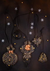 Hand painted Christmas gingerbread on a black background. Close-up.