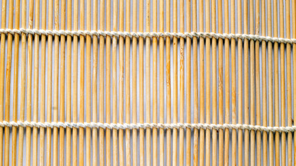 Rolled bamboo sushi mat isolated on white background