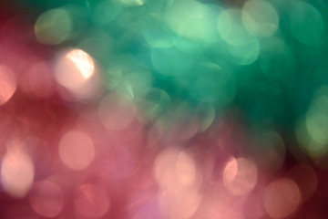 Obraz premium Bokeh photo. Holiday background. Christmas lights. Defocused sparkles. New Year backdrop. Festive wallpaper. Blinks. Carnival. Bokeh retro style photo. Pink.