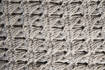 knitted woolen scarf clothing textile canvas for design closeup beige brown sandy natural material knitted braids of thread backround texture vintage fashionable style warm clothes