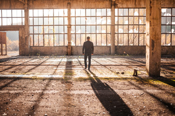 Handsome Man walk thru the Empty Factory