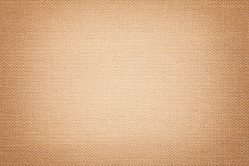 Light brown background from a textile material with wicker pattern, closeup.