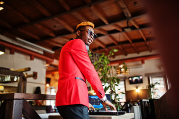Fashion african american man model DJ at red suit with dj controller.