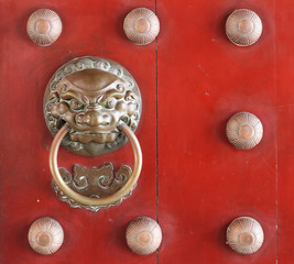 Ancient door handle on wood texture background