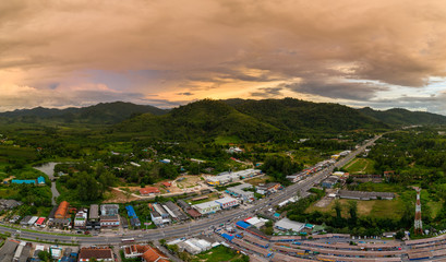 Aerial view of a colorful tropical sunset over a small coastal town in Thailand