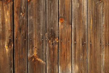 A wall made of old planks connected by nails.Background.