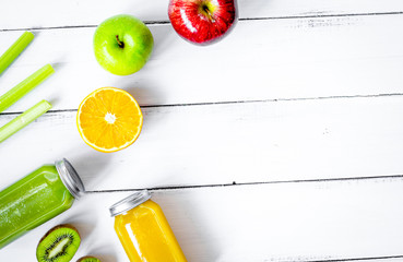 freshly squeezed juices for detox on wooden background top view