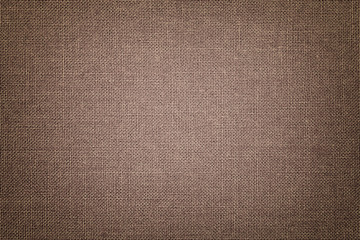 Brown background from a textile material with wicker pattern, closeup.