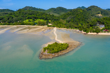 Fototapeta na wymiar Aerial view of a small offshore island connected by a small, winding line of sand to a beautiful tropical island