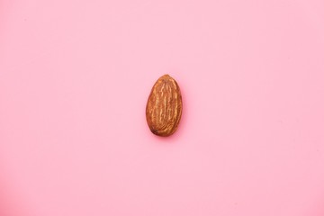 Almond, Nuts on pink background.