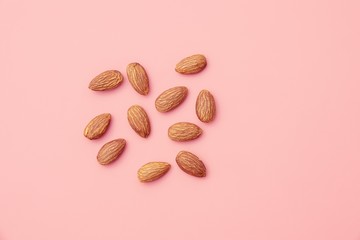 Almond, Nuts on pink background.