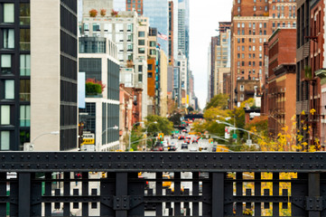 (selective focus) Blurred view from the High Line, Street traffic and buildings in Chelsea, New York, USA.