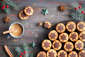 Christmas cookies with chocolate star pattern with espresso, spices and decorated fir twigs