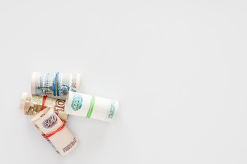 top view of various russian rolled banknotes on white surface