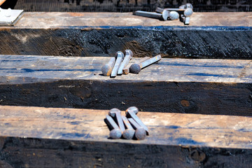 Close up of railroad spikes on wooden sleeper
