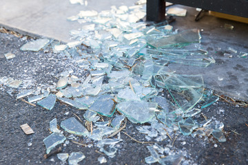 damage concept - shards of broken glass on floor
