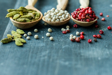 Close up three wooden spoons with colorful spices