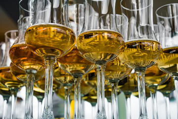 Dear Scotch whiskey in branded glasses on a high leg.