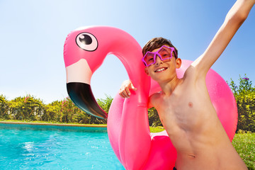 Joyful teenage boy playing by the swimming pool © Sergey Novikov