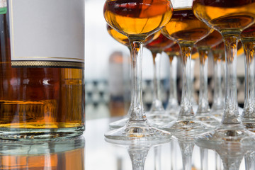 Dear Scotch whiskey in branded glasses on a high leg.