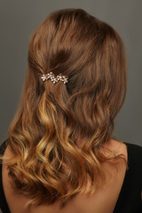 Close up isolated portrait of a young lady with wavy ombre hair. The back view of the girl with...