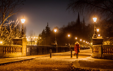 Long exposure of woman walking across a bridge in Newcastle