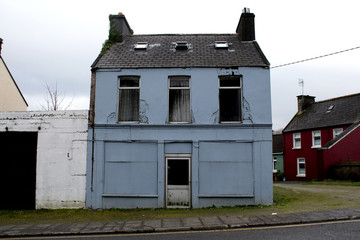 Old house by the side of the road falling apart